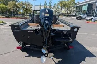 Slide: The Image of 2026 Tracker Targa V-18 WT boat, rear view with outboard motor, parked outdoors. - 5
