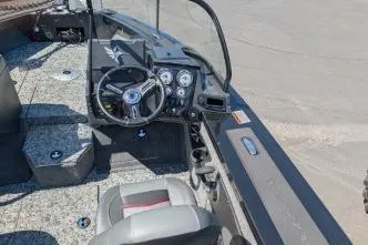 Slide: The Image of 2026 Tracker Targa V-18 WT boat interior with steering wheel and dashboard controls. - 6