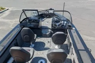Slide: The Image of 2026 Tracker Targa V-18 WT boat interior with seating and steering console. - 7