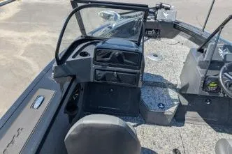 Slide: The Image of 2026 Tracker Targa V-18 WT boat interior with steering console and seating. - 8