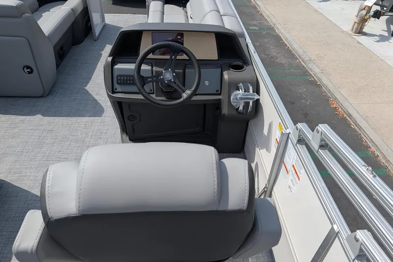 Slide: The Image of 2026 Sun Tracker Party Barge 20 DLX helm with steering wheel and seating. - 7