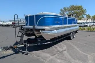 Slide: The Image of 2026 Sun Tracker Party Barge 22 RF XP3 pontoon boat on trailer in parking lot. - 3