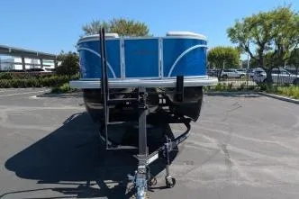 Slide: The Image of 2026 Sun Tracker Party Barge 22 RF XP3 pontoon boat on trailer in parking lot. - 7