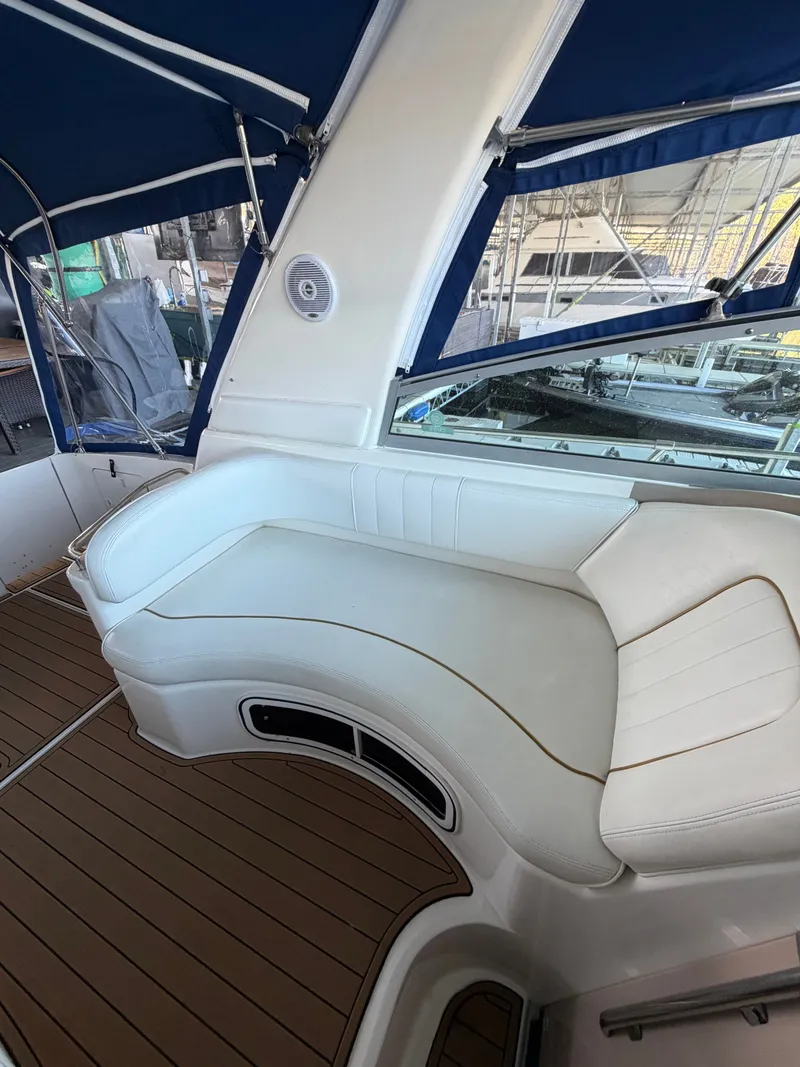Slide: The Image of Interior of a 2001 Sea Ray 290 Sundancer with white seating area. - 11