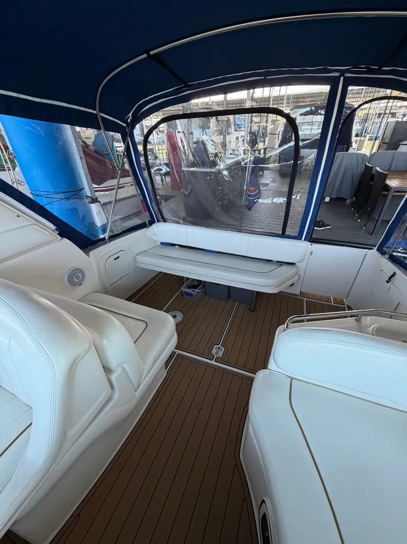 Slide: The Image of Interior of a 2001 Sea Ray 290 Sundancer yacht with seating area. - 13