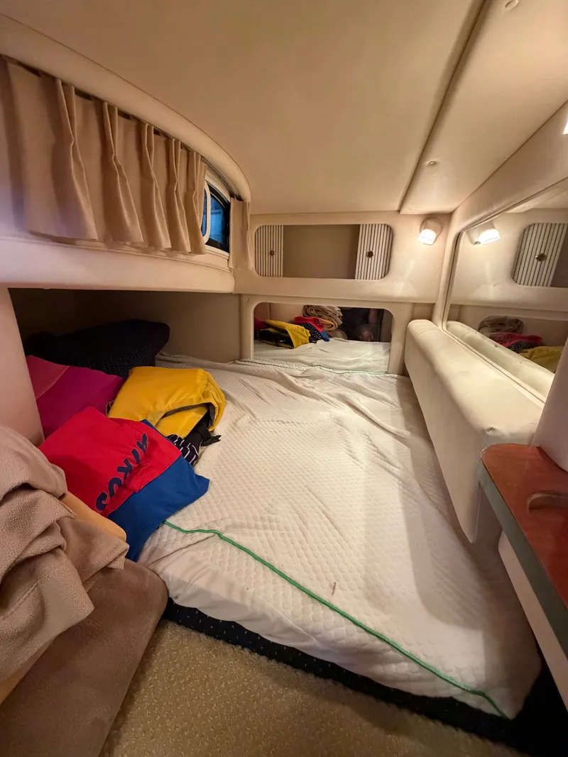 Slide: The Image of Interior of 2001 Sea Ray 290 Sundancer with cozy sleeping area. - 15