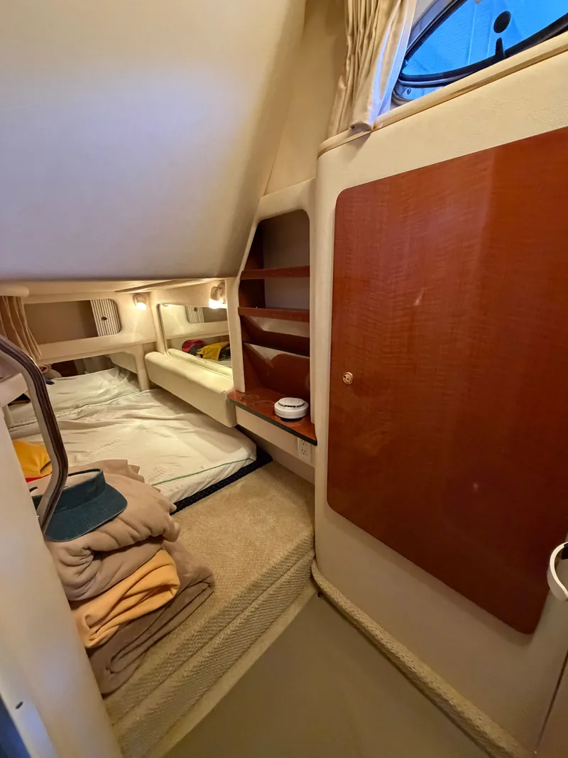 Slide: The Image of Interior of 2001 Sea Ray 290 Sundancer with cozy sleeping area. - 16