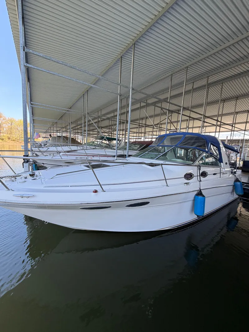 Slide: The Image of 2001 Sea Ray 290 Sundancer docked under covered marina. - 2