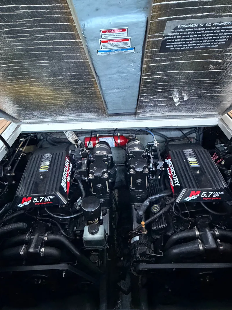 Slide: The Image of Engine compartment of 2001 Sea Ray 290 Sundancer with Mercury 5.7L engines. - 21