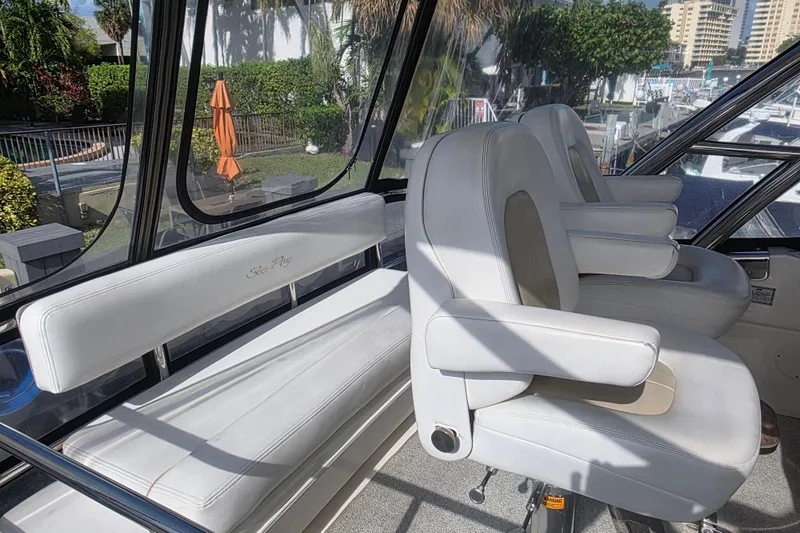 Slide: The Image of 2008 Sea Ray 47 Sedan Bridge interior with white seating and helm chairs. - 11
