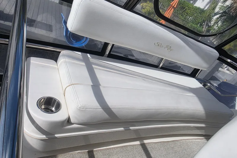 Slide: The Image of Luxurious white seating on 2008 Sea Ray 47 Sedan Bridge yacht, featuring cup holder. - 12