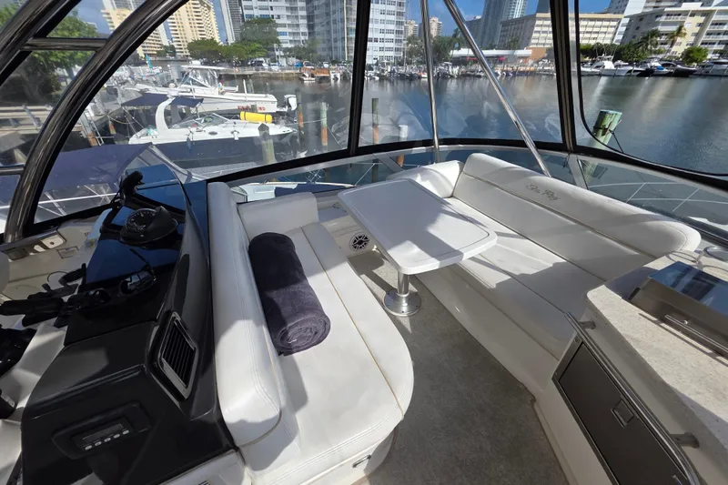 Slide: The Image of Luxurious 2008 Sea Ray 47 Sedan Bridge interior with plush seating and marina view. - 14