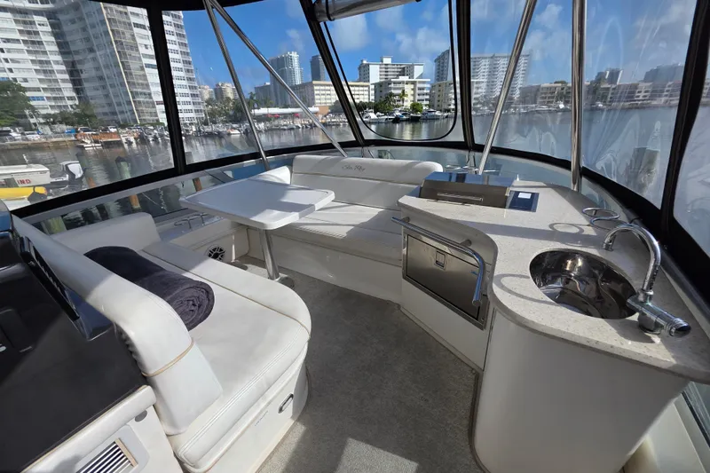 Slide: The Image of Luxurious interior of 2008 Sea Ray 47 Sedan Bridge yacht with seating and kitchenette. - 16