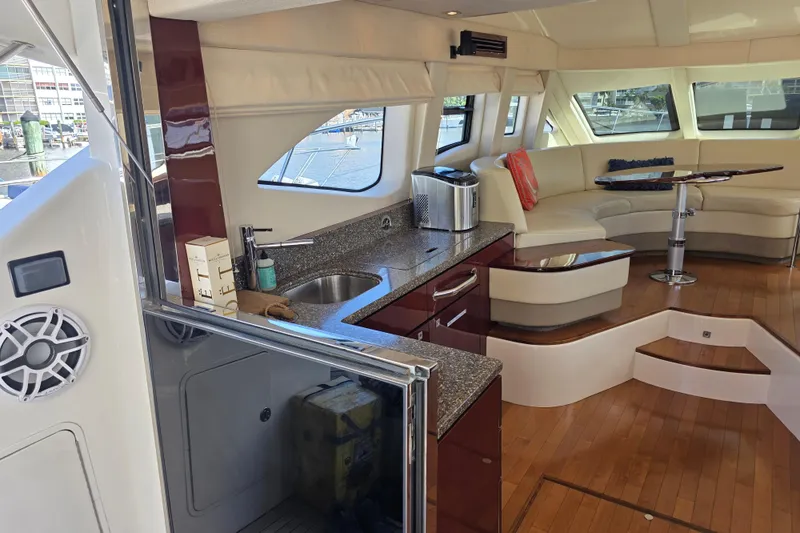 Slide: The Image of Luxurious interior of a 2008 Sea Ray 47 Sedan Bridge yacht with modern kitchen and seating area. - 19