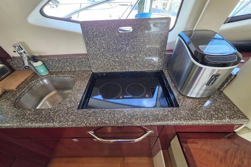 Slide: The Image of Luxurious 2008 Sea Ray 47 Sedan Bridge kitchen with granite countertop and modern appliances. - 22