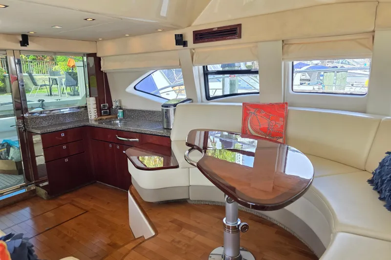 Slide: The Image of Luxurious interior of 2008 Sea Ray 47 Sedan Bridge yacht with elegant seating and modern kitchen. - 25