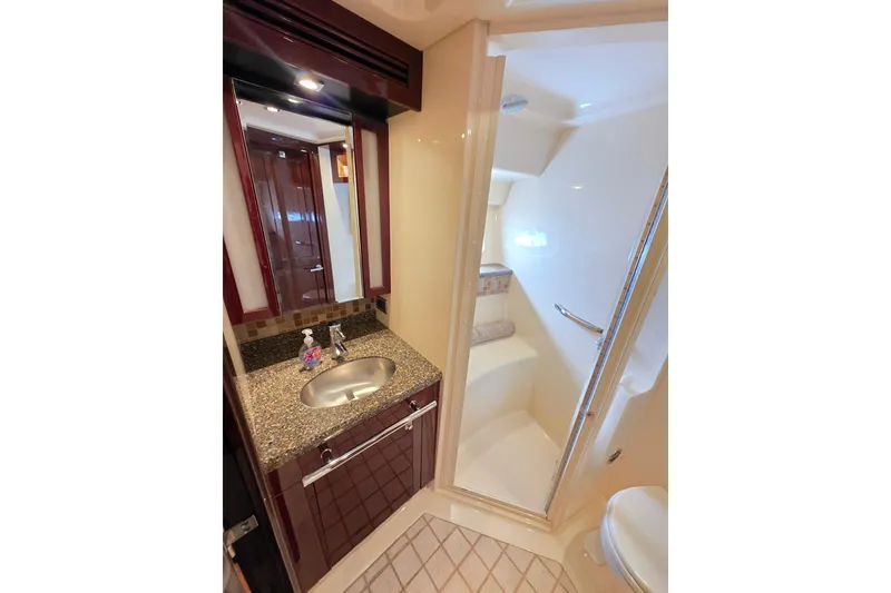 Slide: The Image of Luxurious bathroom in 2008 Sea Ray 47 Sedan Bridge yacht with granite countertop and shower. - 34