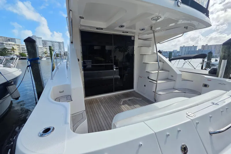 Slide: The Image of 2008 Sea Ray 47 Sedan Bridge yacht docked, featuring spacious deck and modern design. - 8