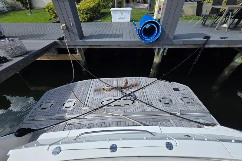 Slide: The Image of 2008 Sea Ray 47 Sedan Bridge yacht docked, showing rear deck and mooring lines. - 9