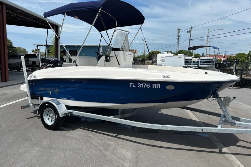 The Image of 2018 Bayliner Element F16 boat on trailer with blue hull and canopy. - 1