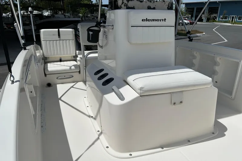 Slide: The Image of 2018 Bayliner Element F16 boat interior with white seating and console. - 10