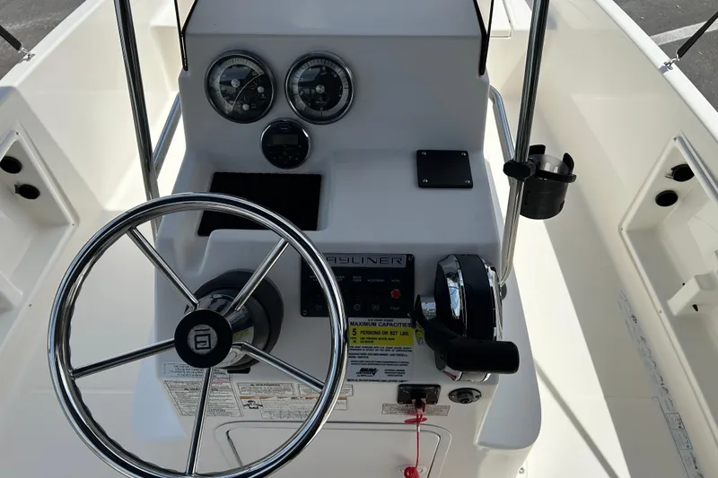 Slide: The Image of 2018 Bayliner Element F16 boat dashboard with steering wheel and control panel. - 11