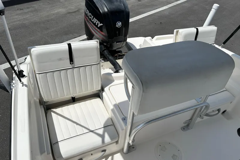 Slide: The Image of 2018 Bayliner Element F16 boat interior with white seating and Mercury outboard motor. - 13