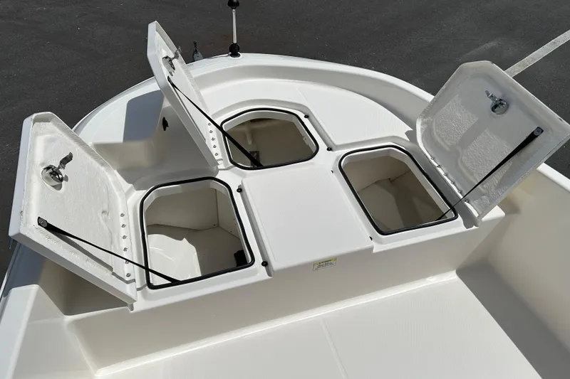 Slide: The Image of 2018 Bayliner Element F16 boat storage compartments open on deck. - 14