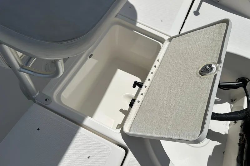 Slide: The Image of 2018 Bayliner Element F16 boat storage compartment with open hatch. - 16