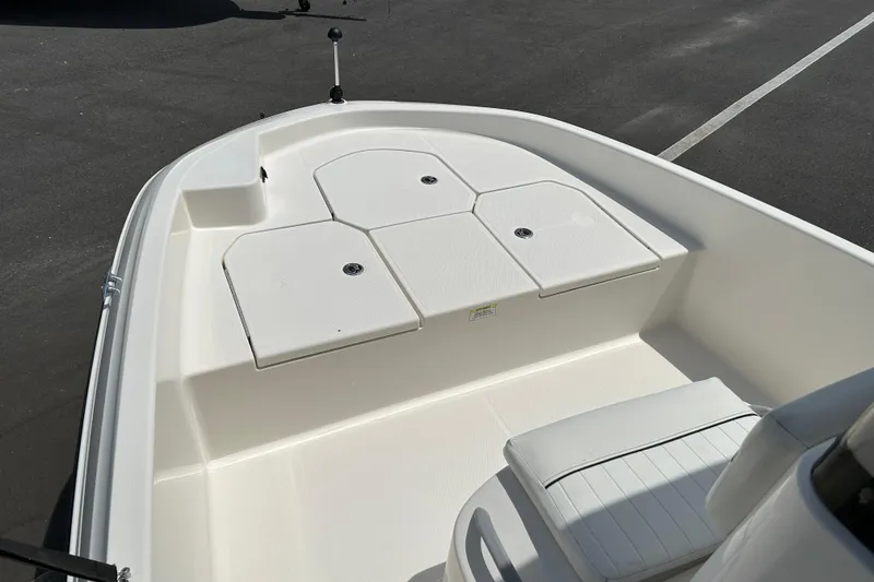 Slide: The Image of 2018 Bayliner Element F16 boat interior with white seating and storage compartments. - 8