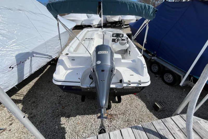 Slide: The Image of 2015 Hurricane SunDeck Sport 201 OB boat with outboard motor, docked and covered. - 10