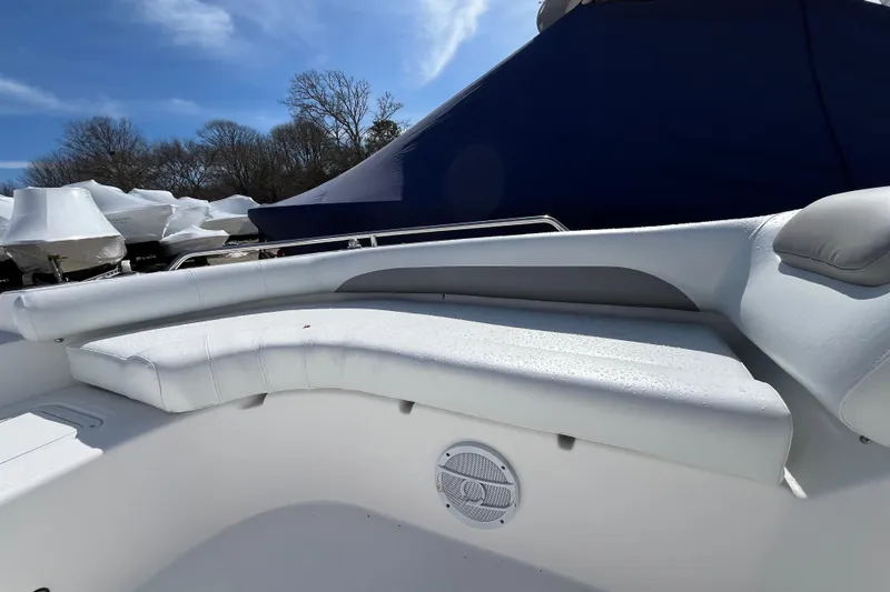 Slide: The Image of 2015 Hurricane SunDeck Sport 201 OB boat interior with white seating and speaker. - 14