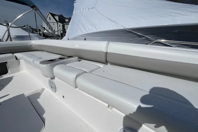 Slide: The Image of 2015 Hurricane SunDeck Sport 201 OB boat interior with cushioned seating and cup holders. - 17