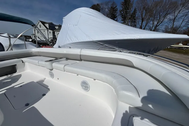 Slide: The Image of 2015 Hurricane SunDeck Sport 201 OB boat interior with cushioned seating and covered exterior. - 18