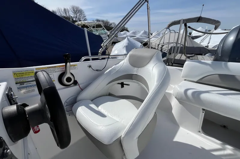 Slide: The Image of 2015 Hurricane SunDeck Sport 201 OB boat interior with steering wheel and seating. - 22