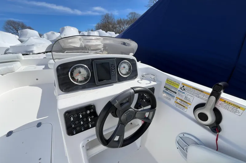 Slide: The Image of 2015 Hurricane SunDeck Sport 201 OB boat dashboard with steering wheel and gauges. - 24
