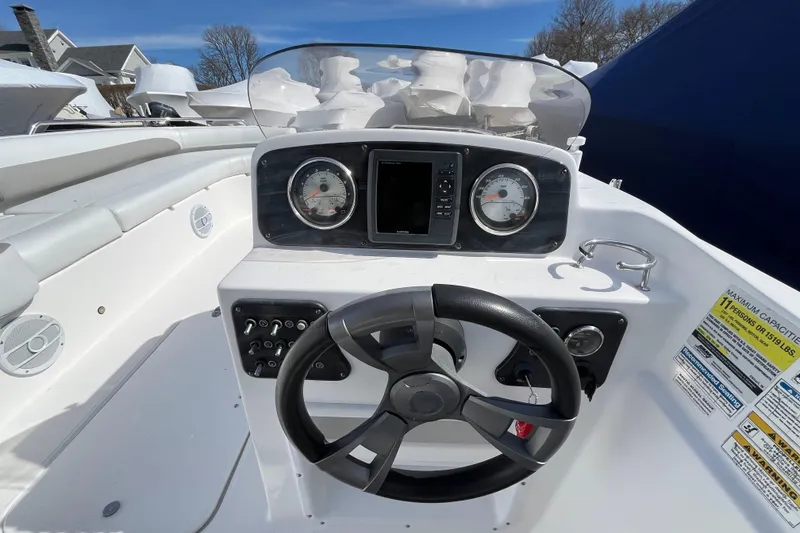 Slide: The Image of 2015 Hurricane SunDeck Sport 201 OB boat dashboard with steering wheel and gauges. - 25