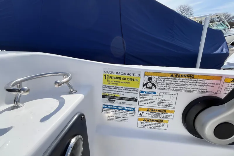 Slide: The Image of 2015 Hurricane SunDeck Sport 201 OB boat capacity and safety warnings displayed. - 26