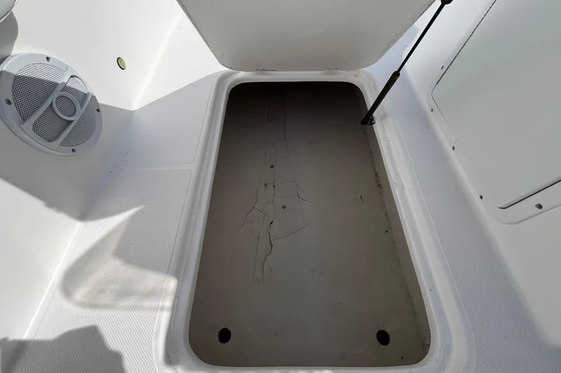 Slide: The Image of Open storage compartment on 2015 Hurricane SunDeck Sport 201 OB boat. - 27
