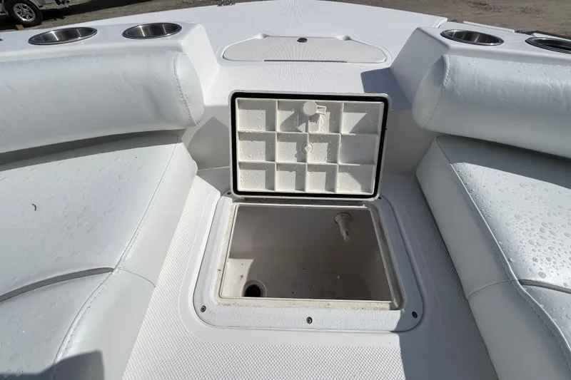 Slide: The Image of 2015 Hurricane SunDeck Sport 201 OB boat interior with open storage compartment. - 29