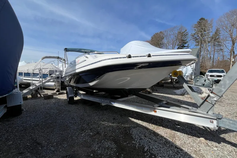 Slide: The Image of 2015 Hurricane SunDeck Sport 201 OB boat on trailer, parked outdoors. - 5