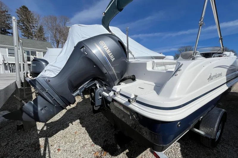 Slide: The Image of 2015 Hurricane SunDeck Sport 201 OB boat with Yamaha outboard motor on trailer. - 7