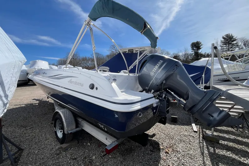 Slide: The Image of 2015 Hurricane SunDeck Sport 201 OB boat with Yamaha outboard motor on trailer. - 9