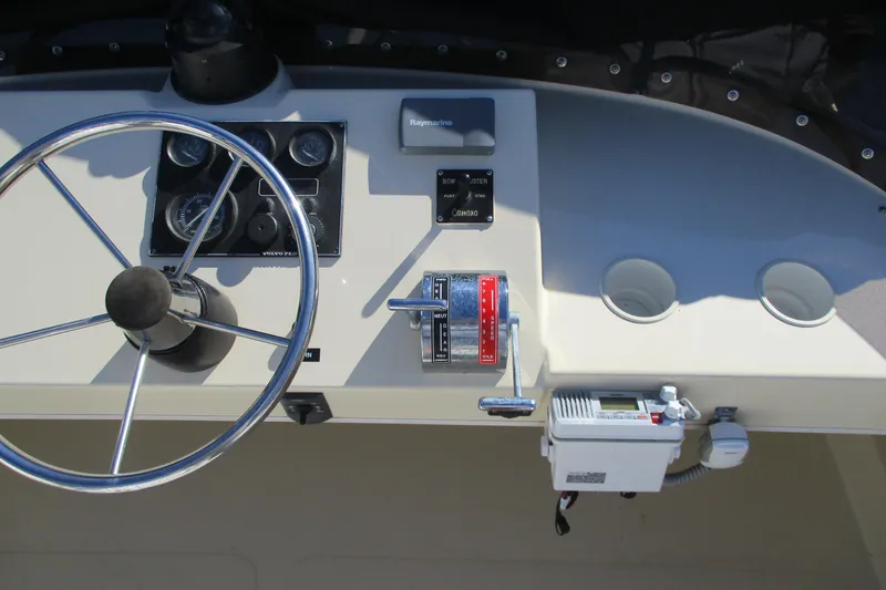 Slide: The Image of 2005 Camano Troll Flybridge helm with steering wheel, gauges, and controls. - 10