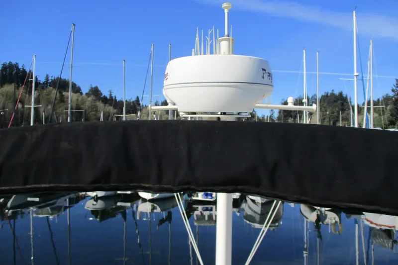 Slide: The Image of 2005 Camano Troll Flybridge with radar, docked in a marina under clear blue skies. - 12