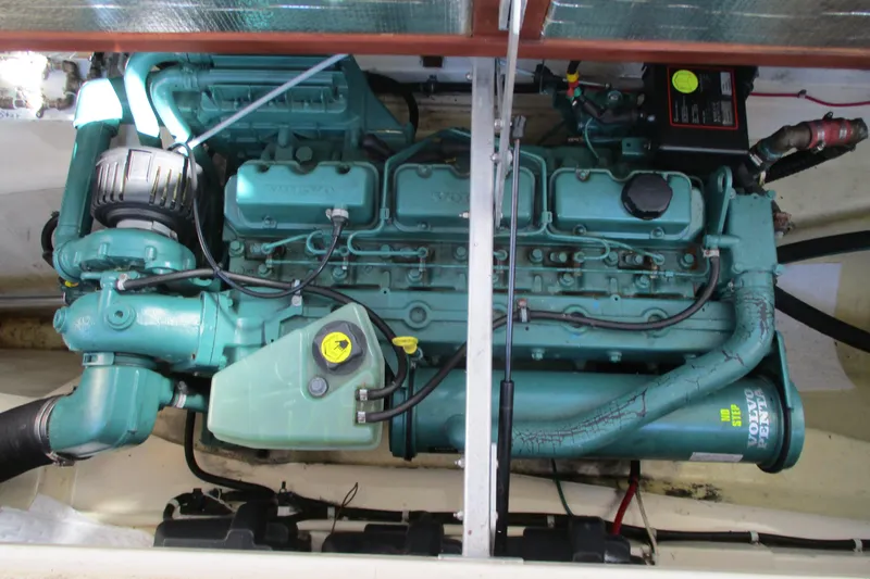 Slide: The Image of Engine compartment of a 2005 Camano Troll Flybridge boat, featuring a Volvo Penta engine. - 43