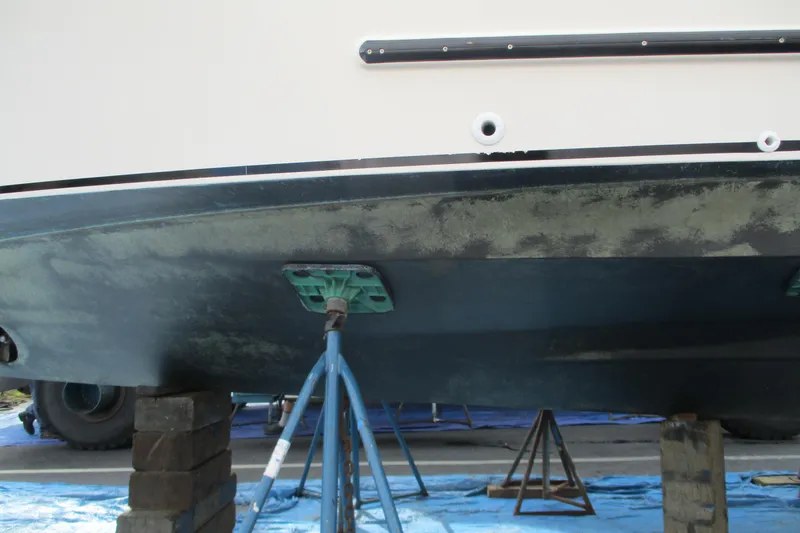 Slide: The Image of 2005 Camano Troll Flybridge boat hull on stands for maintenance. - 58