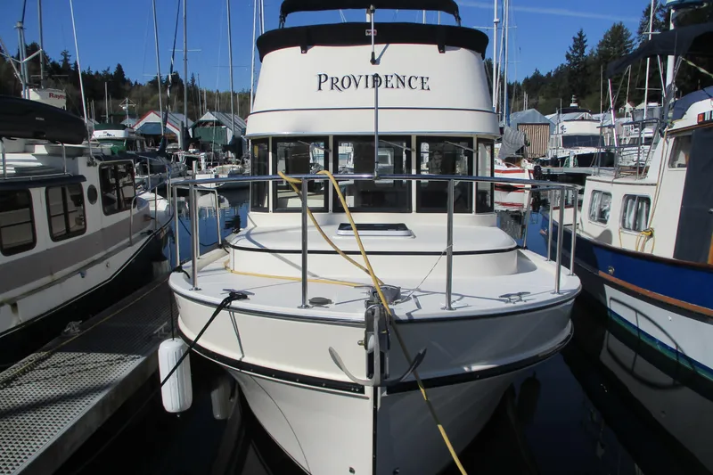 The Image of 2005 Camano Troll boat docked in a marina, surrounded by other vessels. - 0