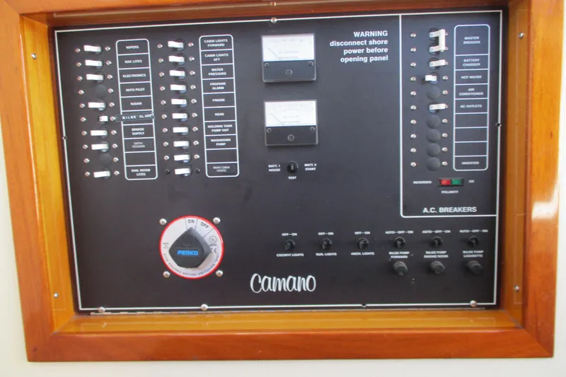 Slide: The Image of Electrical control panel of a 2005 Camano Troll Flybridge boat with switches and gauges. - 24