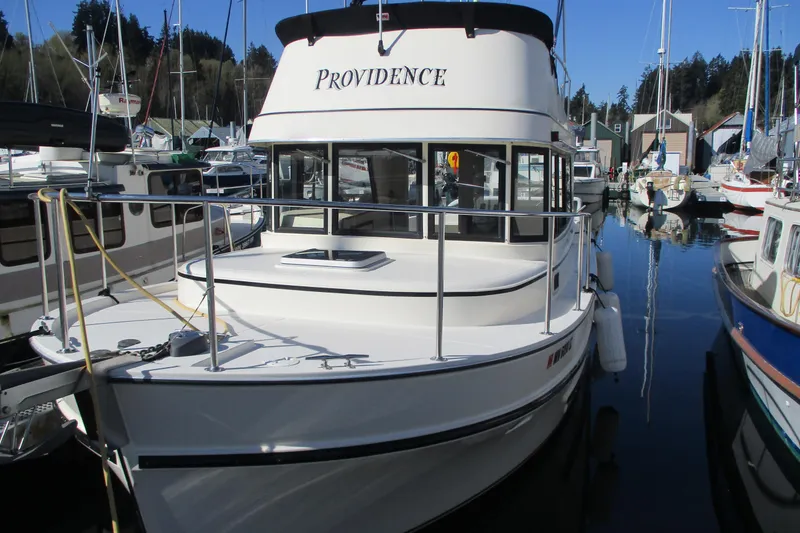Slide: The Image of 2005 Camano Troll boat named "Providence" docked at a marina. - 3